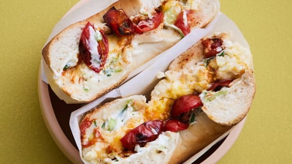 Bagel med cheddaromelett, bakade tomater och lökschmear