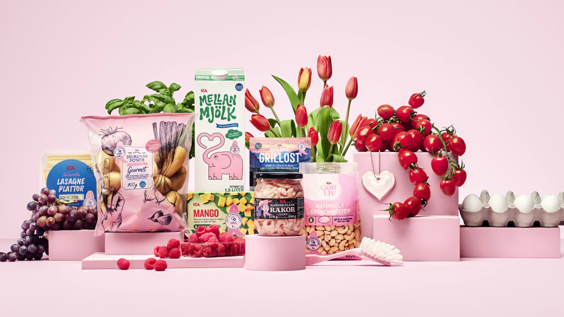 Rosa varor som fryst mango, tulpaner, mjölk, räkor, tomater, potatis med mera står uppställda framför rosa bakgrund.