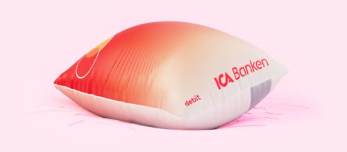 Ett uppblåst bankkort mot en rosa bakgrund.