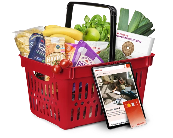 Kundkorg med mat och saker i. En surfplatta och ett bankkort lutar mot korgen.