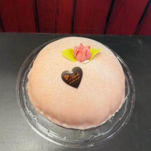 Rosa prinsesstårta med morsdagsdekoration.
