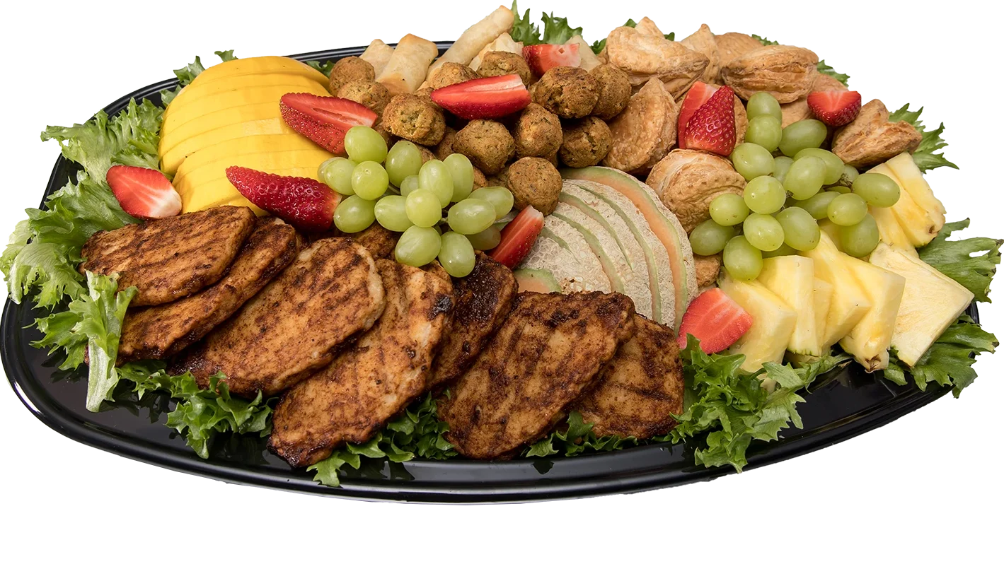 Bricka med quornfilé, falafel, vårrullar, spenatknyten och säsongens frukter.