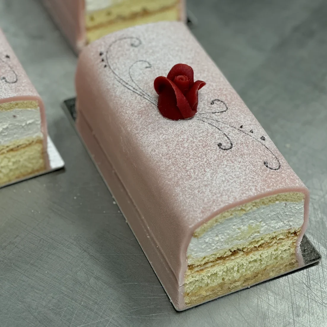 En god stubbe med sockerkaka, vaniljkräm, hallonsylt uppblandad i grädden och rosa marsipan