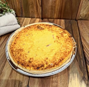 Hel nygräddad ost och skinkpaj på fat