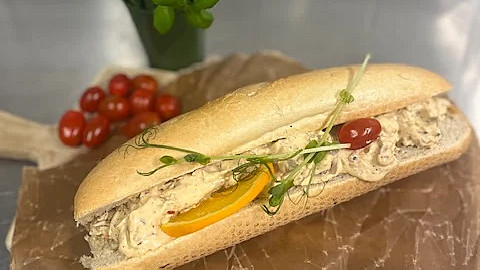 Baguett fylld med kebabröra apelsinskiva och tomat