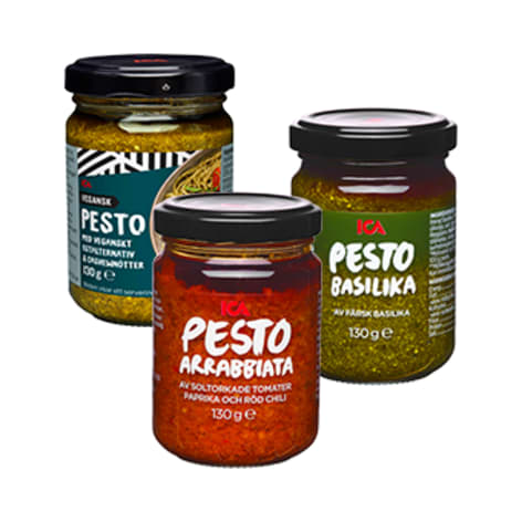 Tre burkar med pesto står på ett underlag.