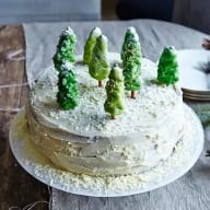 Vit tårta prydd med gröna marsipangranar