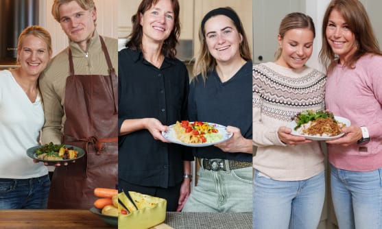 Skidåkare tillsammans med sina mammaor, håller i en tallrik med mat.