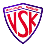 Sköldformat klubbmärke med stora bokstäver "VSK" och texten "Värmlandsbro Sportklubb".